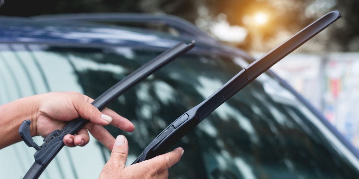 cropped-hands-holding-windshield-wiper-royalty-free-image-1635961668